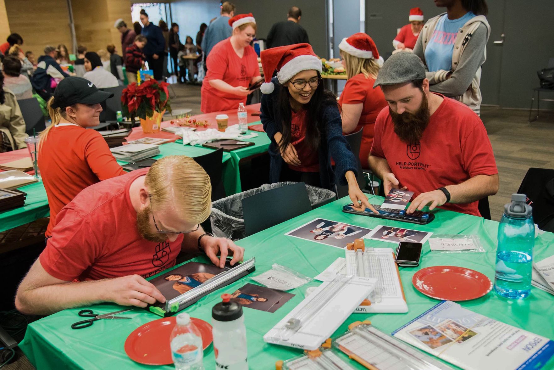 Jordan Faltermeier, Taylor Ardong and Garrett Scarlett cut photos at last year's Help Portrait event